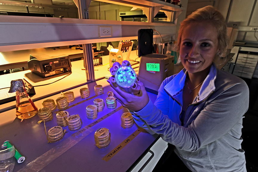 Student with bacterial plate