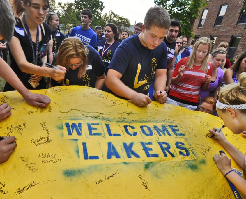 LSSU freshmen sign the rock, a yearly tradition.