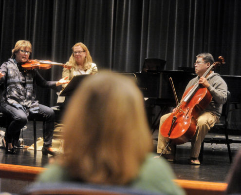 Students learn from the best at a master music class.