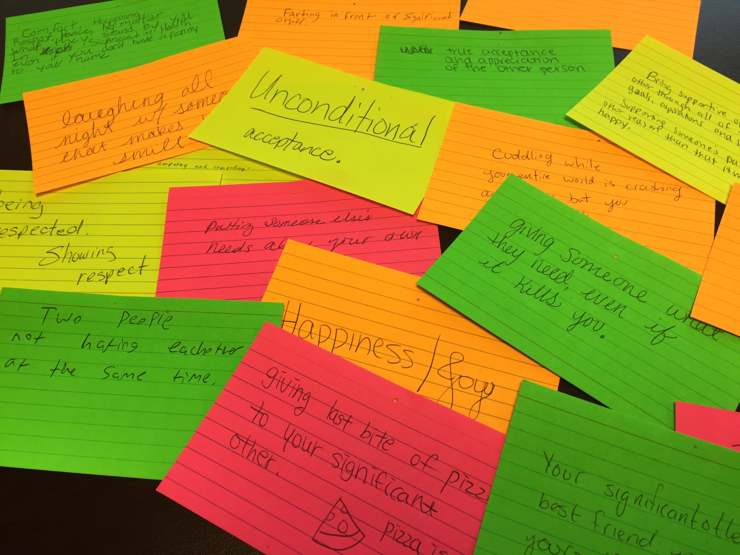 Index cards show the definitions of love submitted by students as part of an interactive display about healthy relationships. 