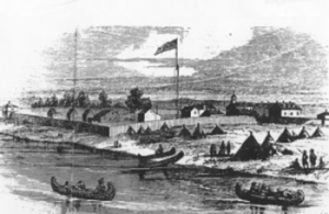 Canoes on shore with fort