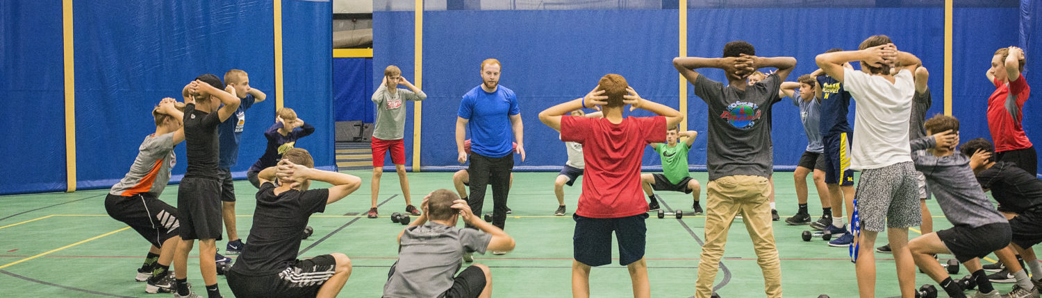 Students squatting at hockey camp