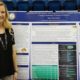 Taylor Steinhelper standing in front of her senior research poster