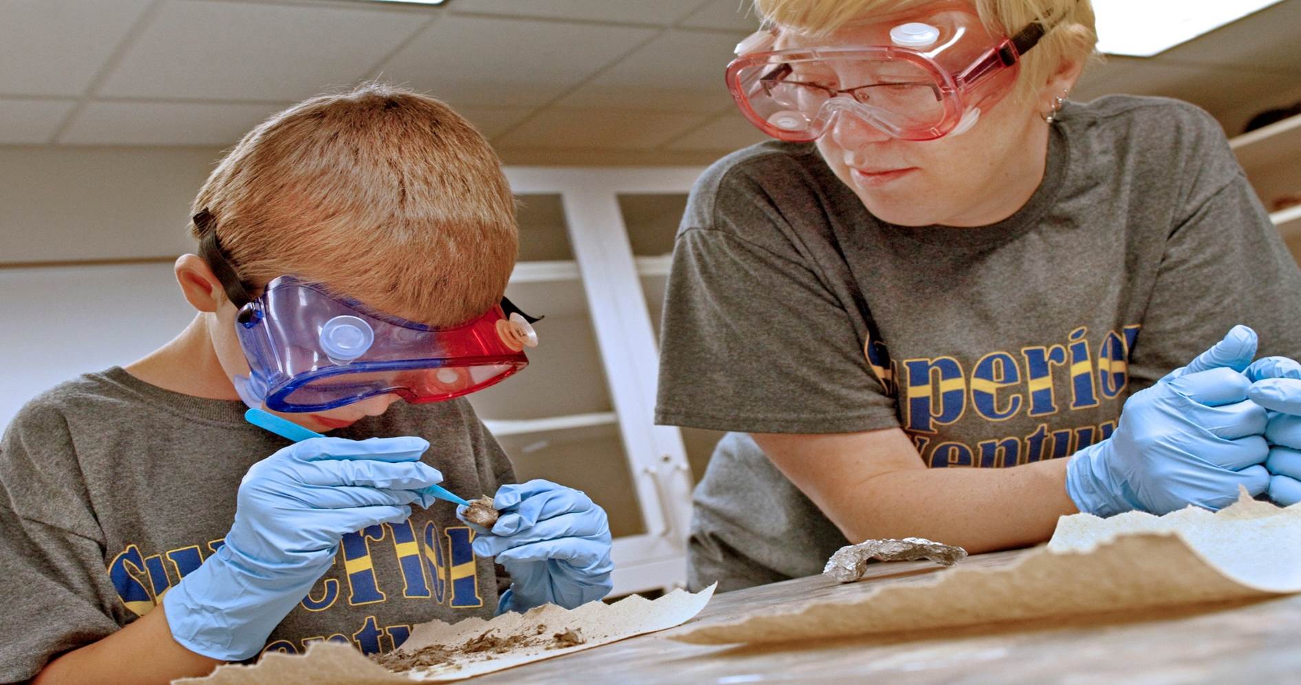 Lake State secondary education student working with student in science camp