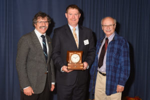 Photo showing previous geology student Todd Fritch accepting the LSSU Outstanding Alumni Award (2016). Professors pictured left and right