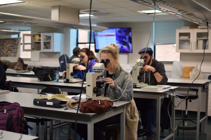 Crawford 339 with students on microscopes.