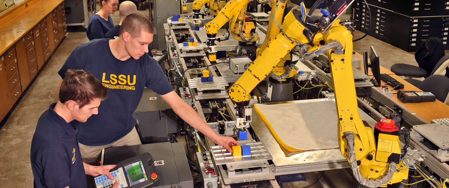 Engineering students with robots