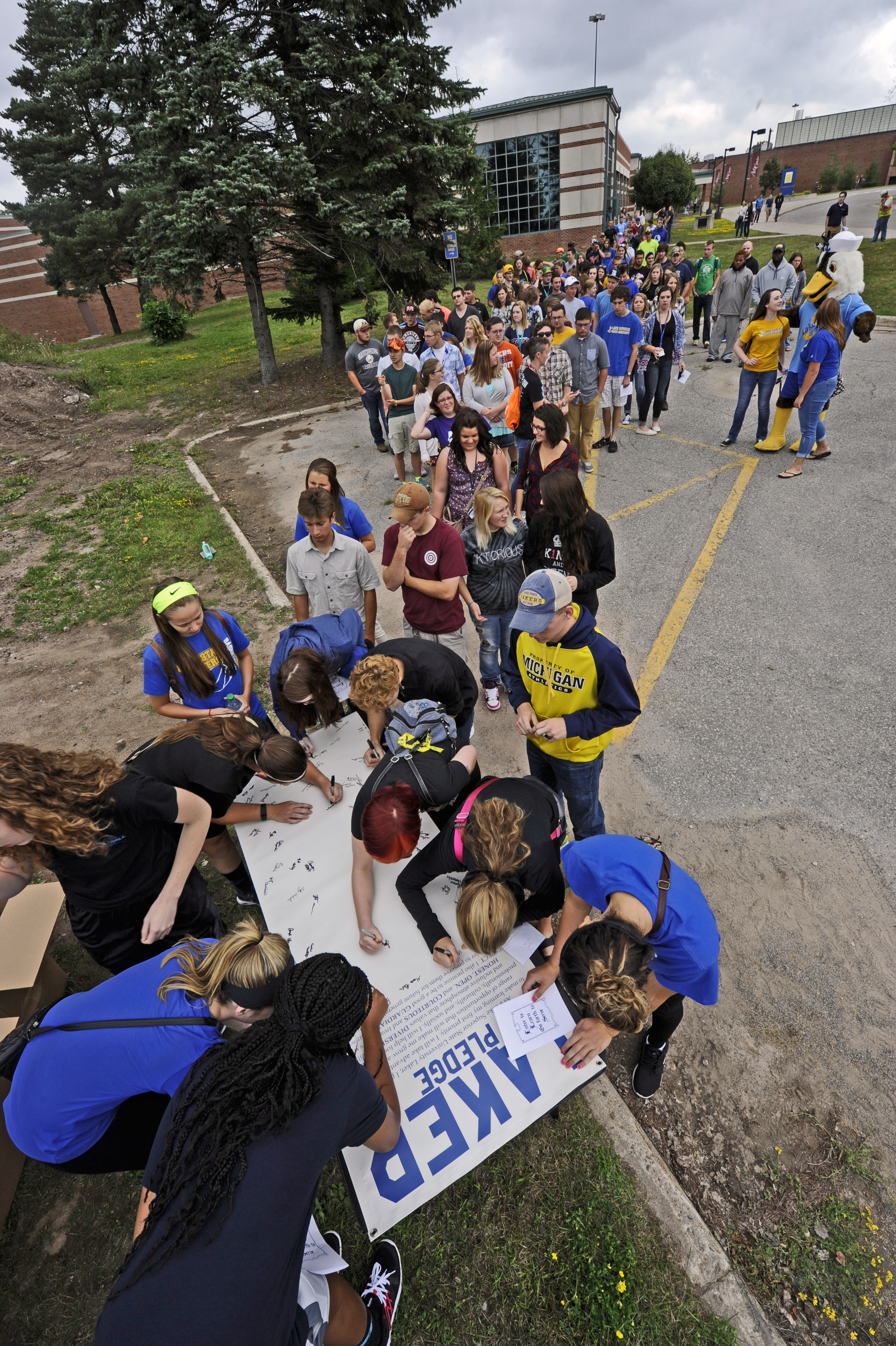 New Student signing new students signing the laker pledge