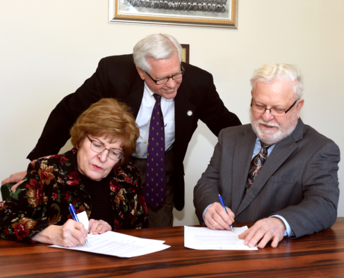 LSSU President Peter T. Mitchell and Sally and Robert Wiles sign to create a scholarship for science majors at Lake State