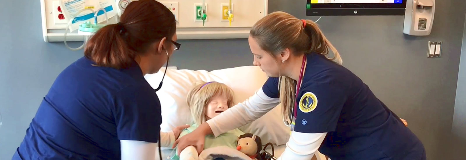 Nursing students working with sim patient