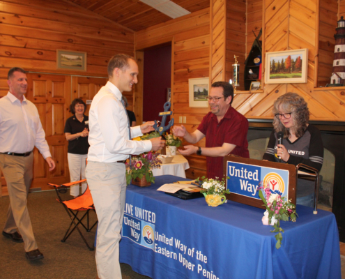 LSSU Athletic Communications Director Mark Vassey accepting the Community Builder Award from Mark and Sharon SanAngelo, 2018 UWEUP Campaign Chairs