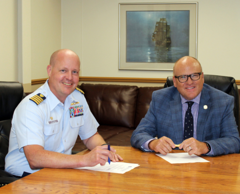 Captain Nelson and President Hanley sign the 10th annual Coast Guard Tuition Agreement