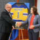 LSSU President Hanley and Governor Whitmer shake hands as she accepts a personalized jersey from LSSU
