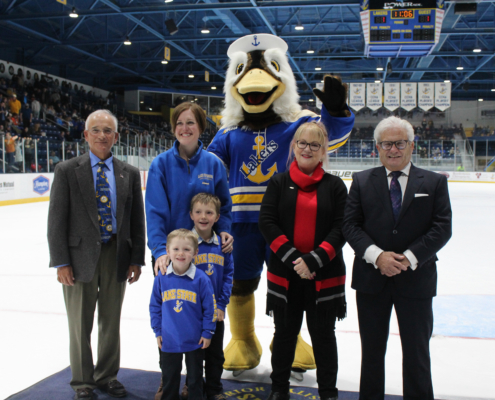 Alumni who were recognized stand on the ice during the GLSW hockey match