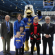 Alumni who were recognized stand on the ice during the GLSW hockey match