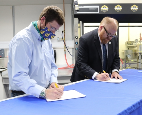 Officials sign the paperwork