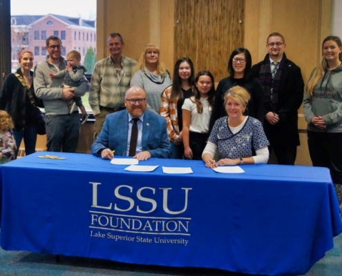 Stakeholders gather to sign the Korson Chippewa County Sunrise Rotary Club Award scholarship.