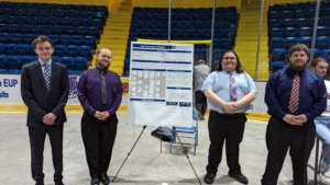 Seniors standing next to their project poster during the campus-wide Senior Research Symposium.