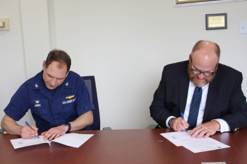 President Hanley (right) and Sector Sault Commander Capt. Anthony Jones renew the annual tuition agreement on June 13, 2022.