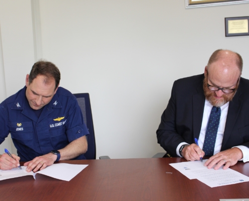 President Hanley (right) and Sector Sault Commander Capt. Anthony Jones renew the annual tuition agreement on June 13, 2022.