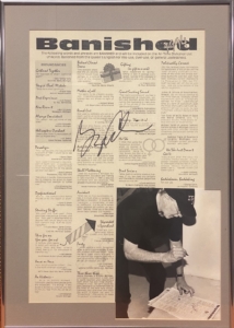 George Carlin signs a Banished Words poster