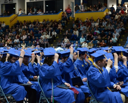Graduates move their tassels at commencement.