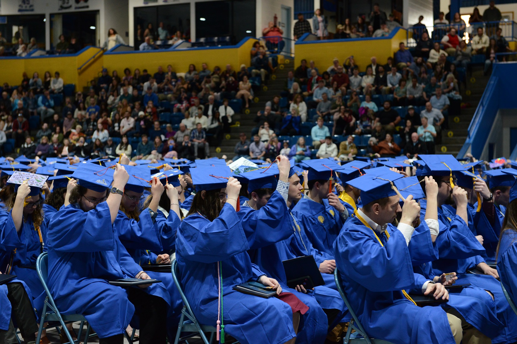 Graduates move their tassels at commencement.