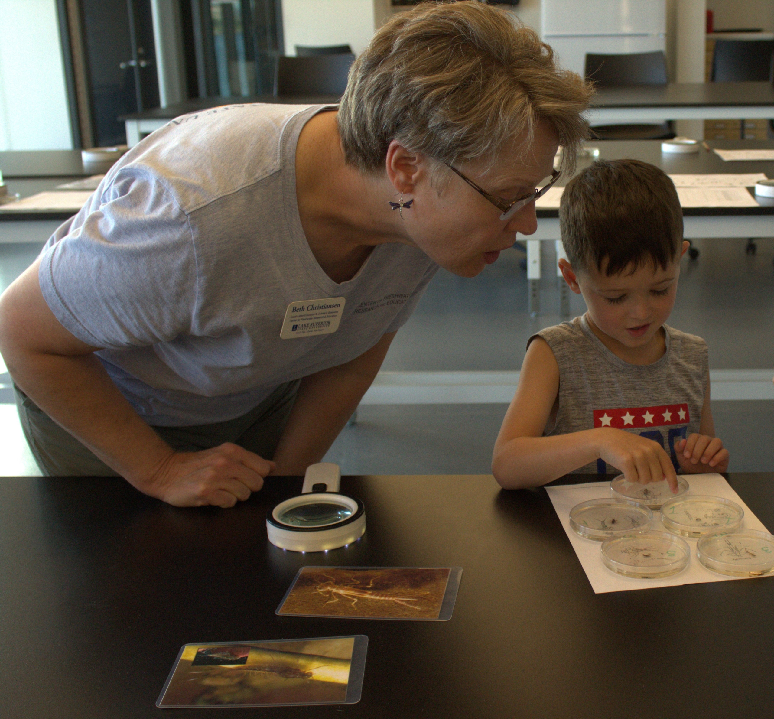 A child looks at samples of bugs.