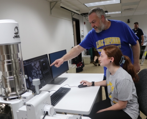 Dr. Derek David Wright, professor of environmental science, and senior biochemistry major Morgan Acker practice on LSSU’s new low vacuum scanning electron microscope.