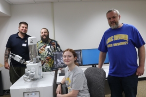 L-R: Associate Professor of Biology Dr. Stephen Kolomyject; Assistant Professor of Chemistry Dr. Mark Zierden; Acker; and Dr. Wright pose with LSSU’s new low vacuum scanning electron microscope.