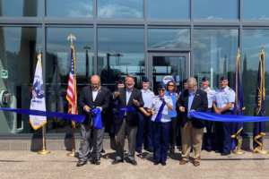 Senator Peters cutting a ribbon to the COE