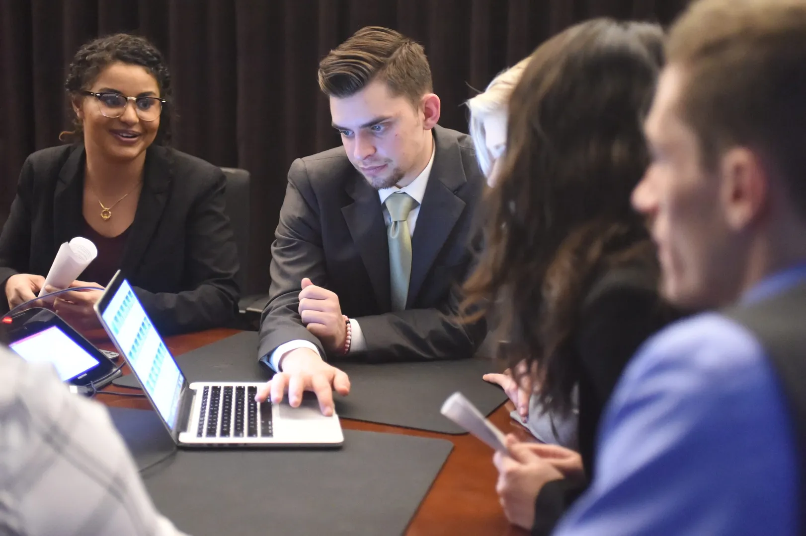 Students looking at a laptop.