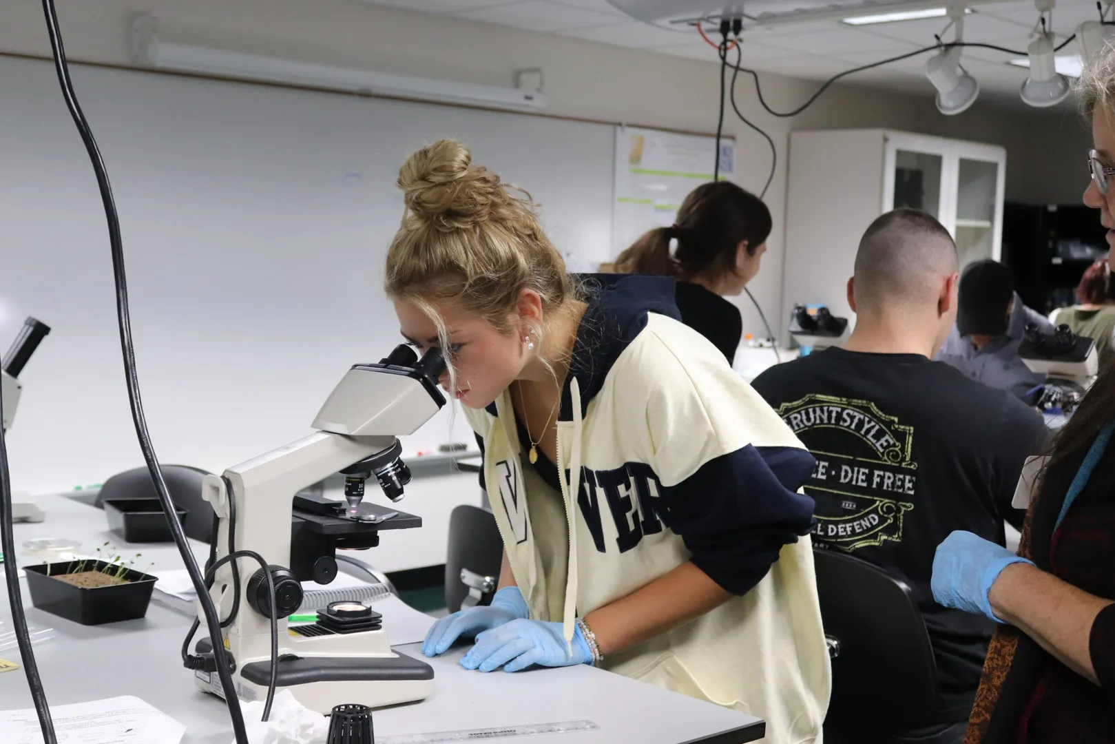 Student looking through a microscope