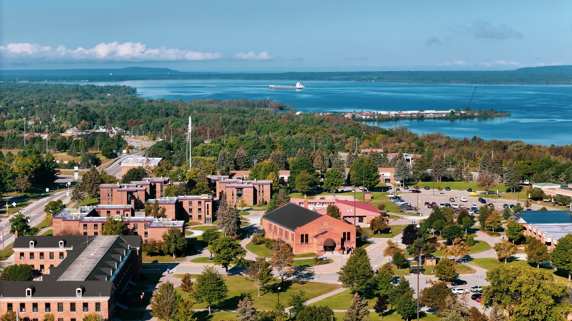 Campus overview shot with freighter on river