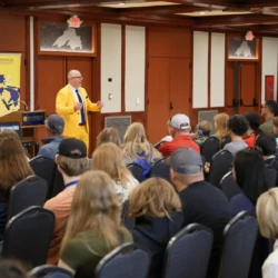 Crowd of attendees watches as VP Dr. Jamie Zamjahn speaks with the crowd.