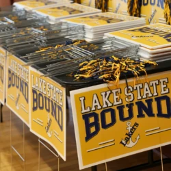 Lake State Bound yard signs covering and lining table.