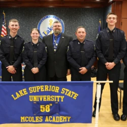 MCOLES Graduates lined up behind banner titling class number