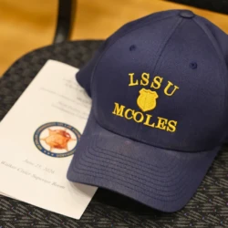 LSSU MCOLES hat on top of chair