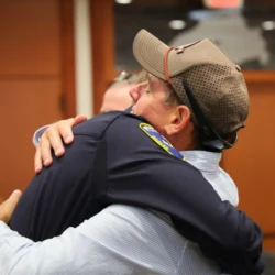 Supporter hugging MCOLE graduate