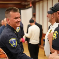 Graduate shakes officers hand