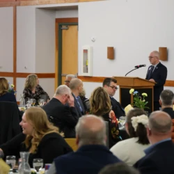 LSB Banquet attendees are seated as University President Dr. David Travis speaks to the audience.