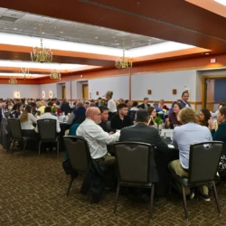 Entire banquet room with students and supported seated throughout.