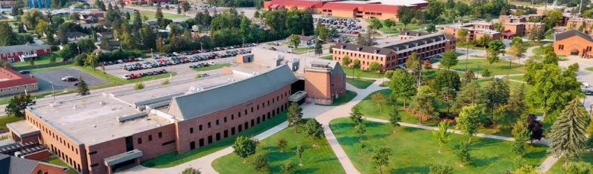 Drone image of LSSU campus and buildings, including the Norris Center, with a water tower visible.